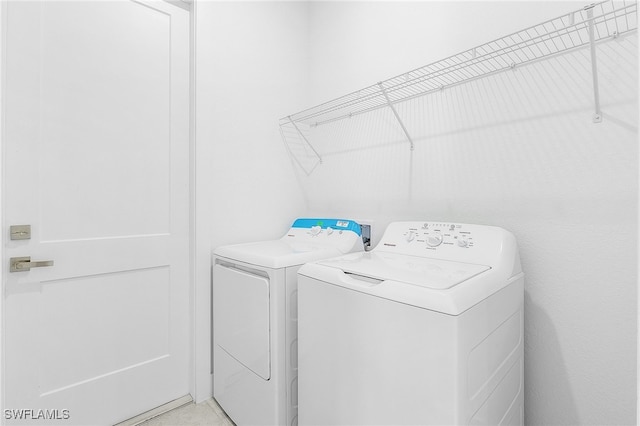 clothes washing area featuring washing machine and clothes dryer