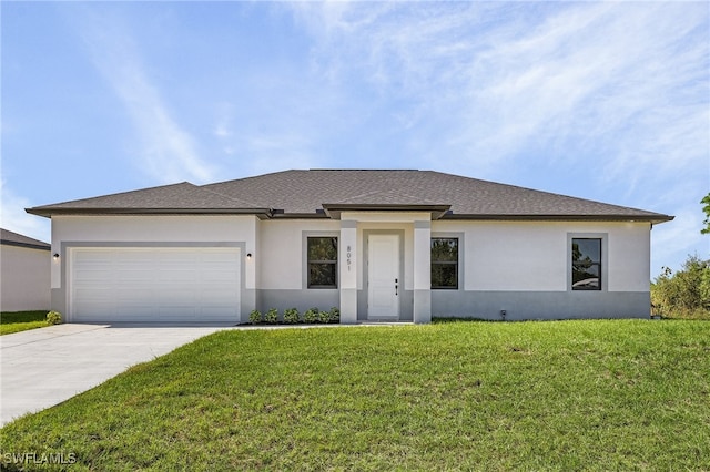 view of front facade with a garage and a front lawn