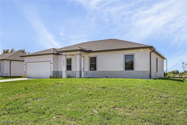 view of front of home with a front yard and a garage