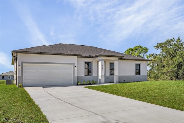 prairie-style home featuring a garage and a front lawn