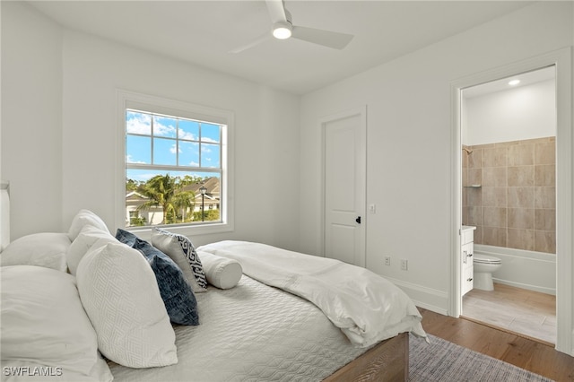 bedroom with connected bathroom, wood-type flooring, and ceiling fan