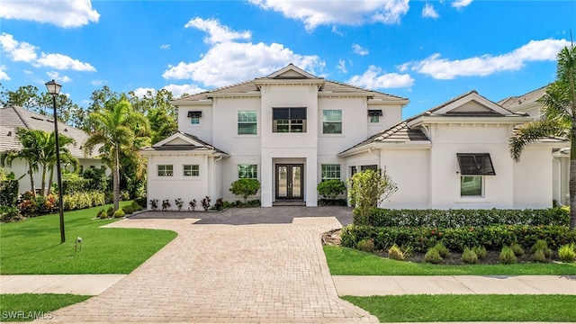 mediterranean / spanish-style house featuring french doors and a front yard