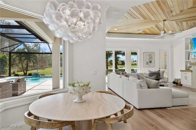 dining space with ceiling fan, light hardwood / wood-style floors, and wooden ceiling