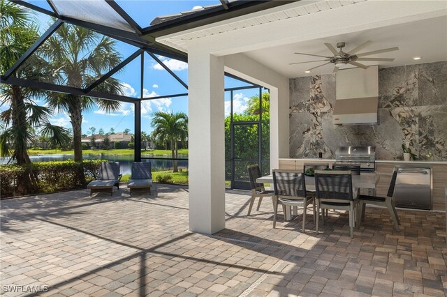 view of patio / terrace featuring area for grilling, a lanai, ceiling fan, a water view, and a grill