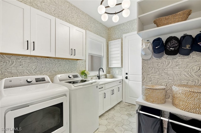 laundry area featuring sink, light tile patterned flooring, separate washer and dryer, and cabinets