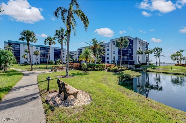 view of community featuring a water view and a lawn