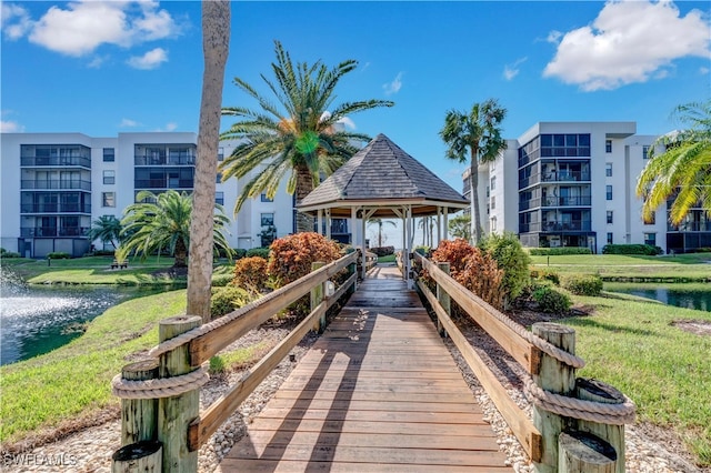 view of property's community with a gazebo, a yard, and a water view