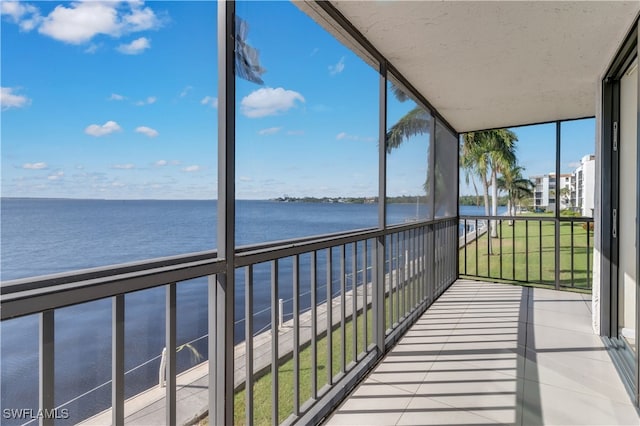 unfurnished sunroom with a water view