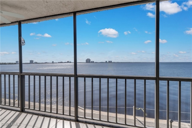 unfurnished sunroom featuring a water view