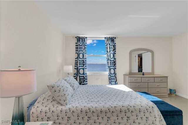 bedroom featuring a water view