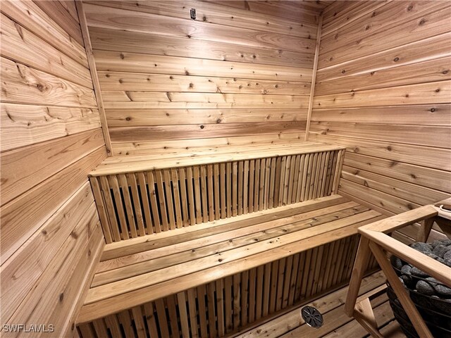 view of sauna / steam room with hardwood / wood-style floors and wooden walls