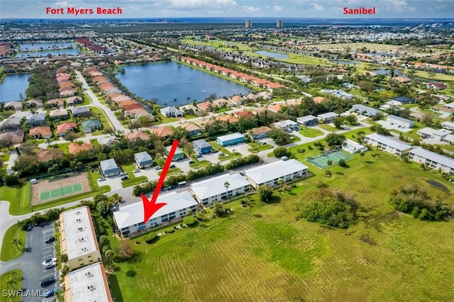 drone / aerial view with a residential view and a water view