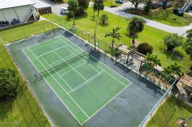 16251 Dublin Cir Unit F104, Fort Myers, FL 33908 - view of tennis court with a lawn and fence
