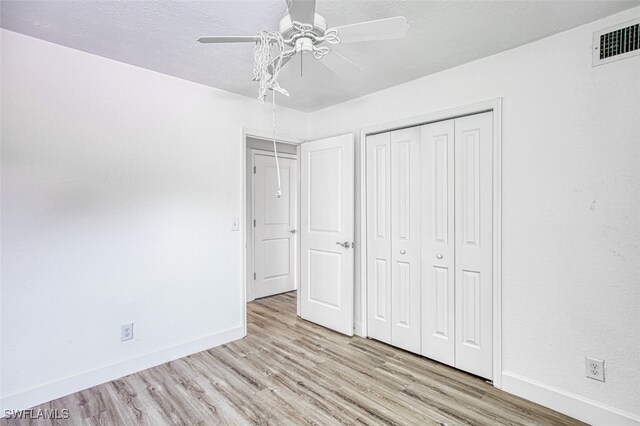 16251 Dublin Cir Unit F104, Fort Myers, FL 33908 - unfurnished bedroom with baseboards, visible vents, wood finished floors, and a closet