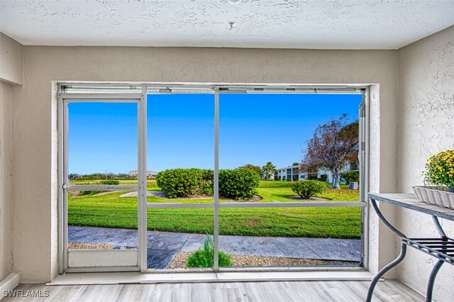 16251 Dublin Cir Unit F104, Fort Myers, FL 33908 - entryway featuring a textured wall and wood finished floors