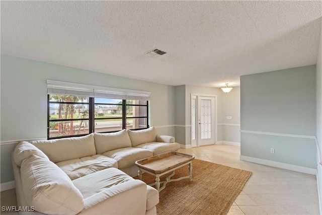 tiled living room with a textured ceiling