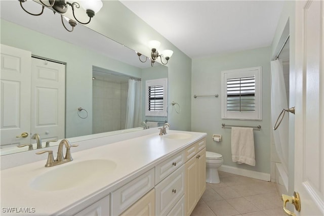 full bathroom featuring a wealth of natural light, tile patterned flooring, vanity, and an inviting chandelier