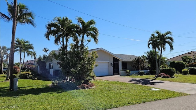 ranch-style house with a garage and a front yard