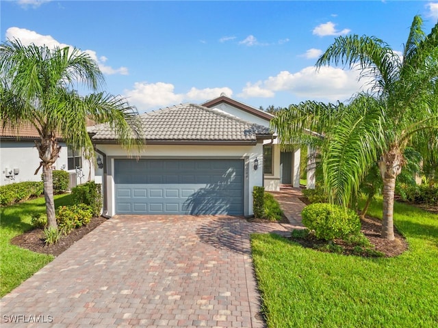 view of front of home featuring a front yard and a garage