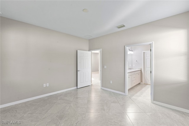 unfurnished bedroom featuring ensuite bathroom