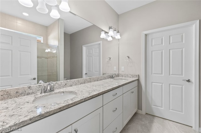 bathroom with vanity and a tile shower