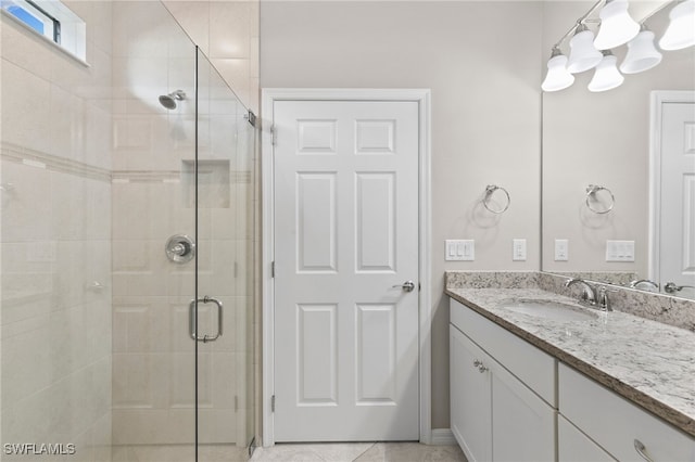 bathroom with vanity, tile patterned flooring, and an enclosed shower