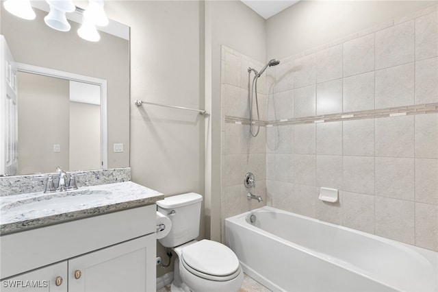 full bathroom featuring toilet, tiled shower / bath combo, and vanity