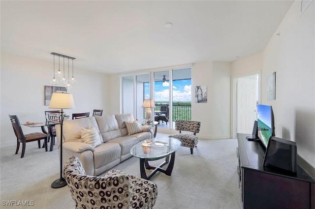 carpeted living room featuring floor to ceiling windows