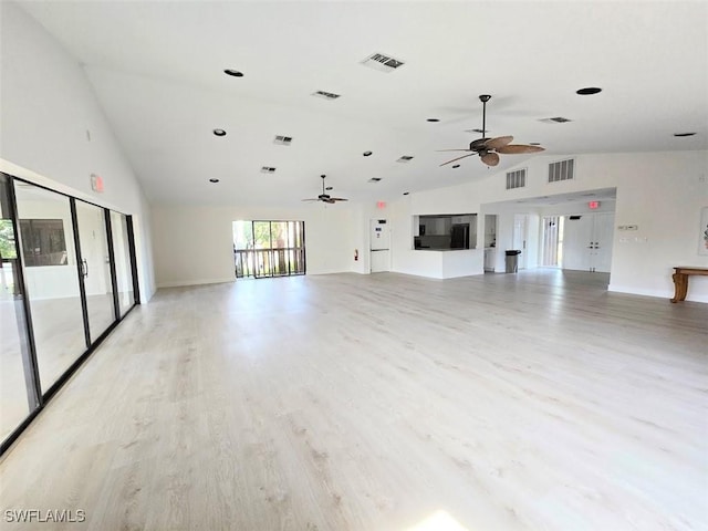 unfurnished living room featuring ceiling fan, high vaulted ceiling, and light wood-type flooring