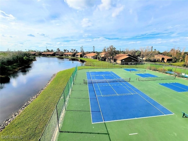 view of sport court with a water view