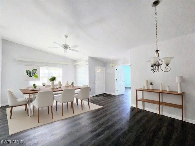 dining space featuring lofted ceiling, ceiling fan with notable chandelier, and dark wood-type flooring