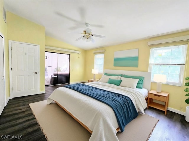 bedroom featuring dark hardwood / wood-style flooring, lofted ceiling, and ceiling fan