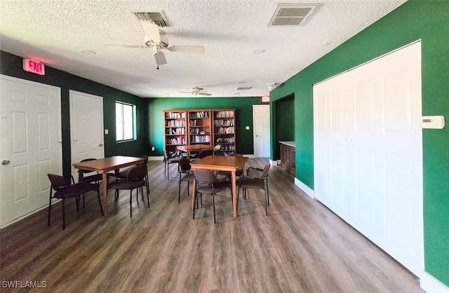 dining room featuring ceiling fan, hardwood / wood-style floors, and a textured ceiling