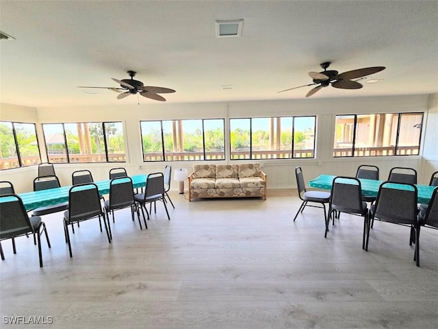 dining space featuring ceiling fan and light hardwood / wood-style floors