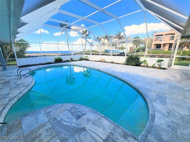 view of swimming pool featuring a patio and glass enclosure