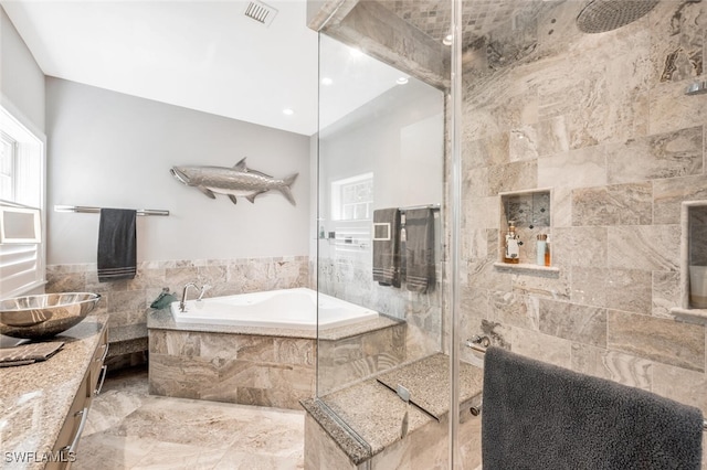 bathroom with tile walls, separate shower and tub, and vanity