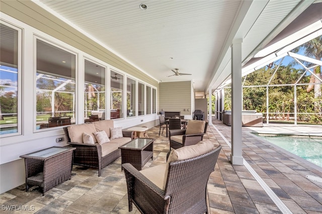 view of patio with glass enclosure, ceiling fan, and an outdoor hangout area