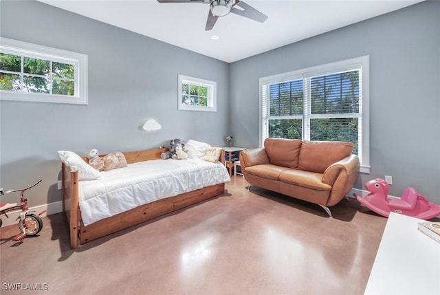 bedroom featuring multiple windows, concrete floors, and ceiling fan