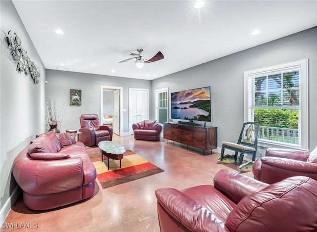 living room featuring concrete floors and ceiling fan