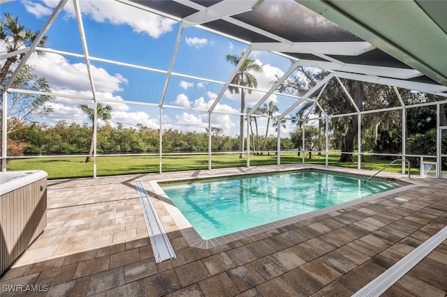 view of swimming pool with a patio area, a lanai, and a lawn