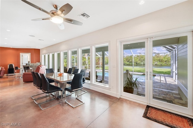 dining room featuring concrete flooring and ceiling fan