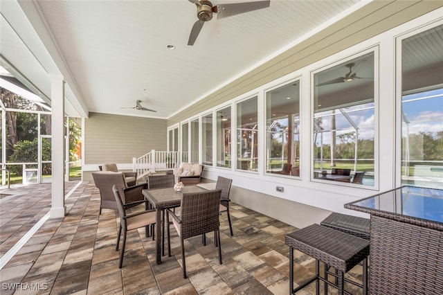 sunroom featuring ceiling fan