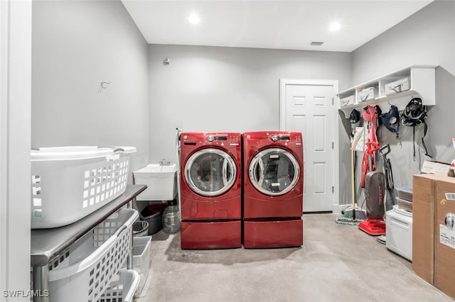 clothes washing area featuring washer and dryer and sink