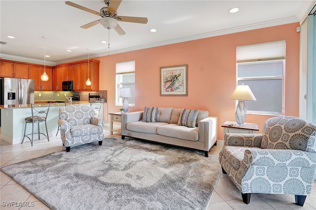 living room featuring crown molding, ceiling fan, and light tile patterned floors