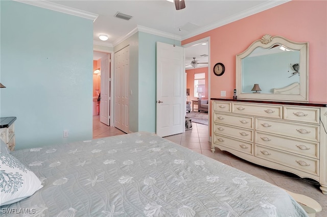 bedroom with crown molding, light tile patterned floors, and ceiling fan