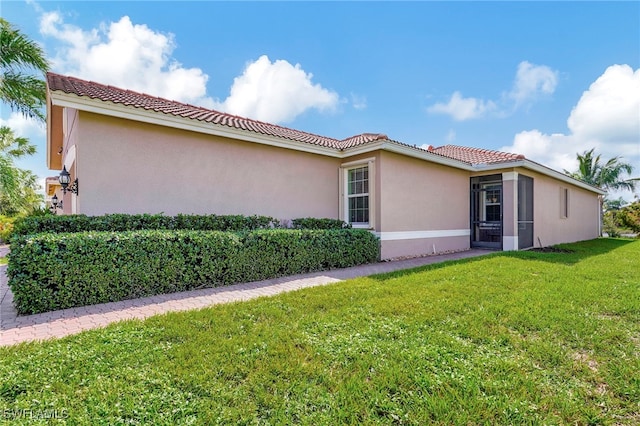 view of side of property with a yard