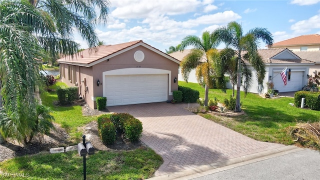 view of front of property with a front lawn and a garage