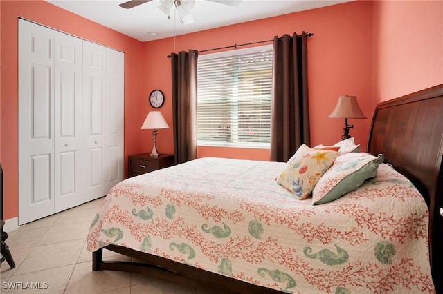 bedroom featuring light tile patterned flooring, a closet, and ceiling fan