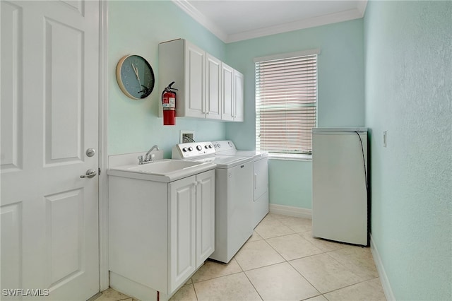 laundry area featuring independent washer and dryer, ornamental molding, sink, light tile patterned floors, and cabinets