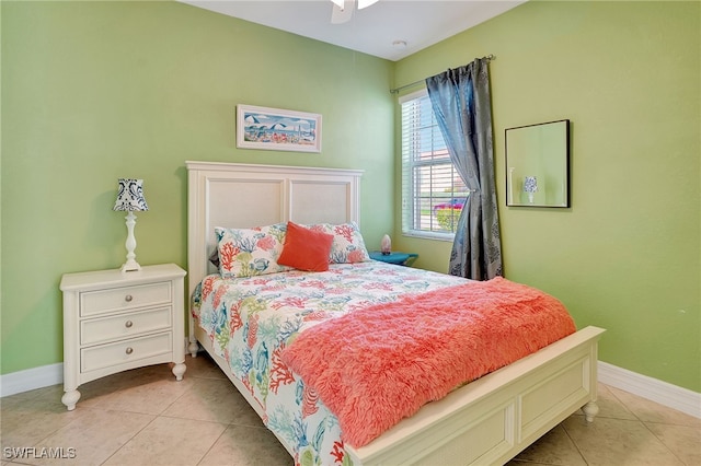 bedroom with ceiling fan and light tile patterned floors